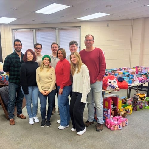 a group of professionals volunteering to organize toys