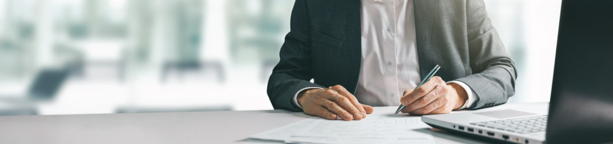 man at computer with paperwork